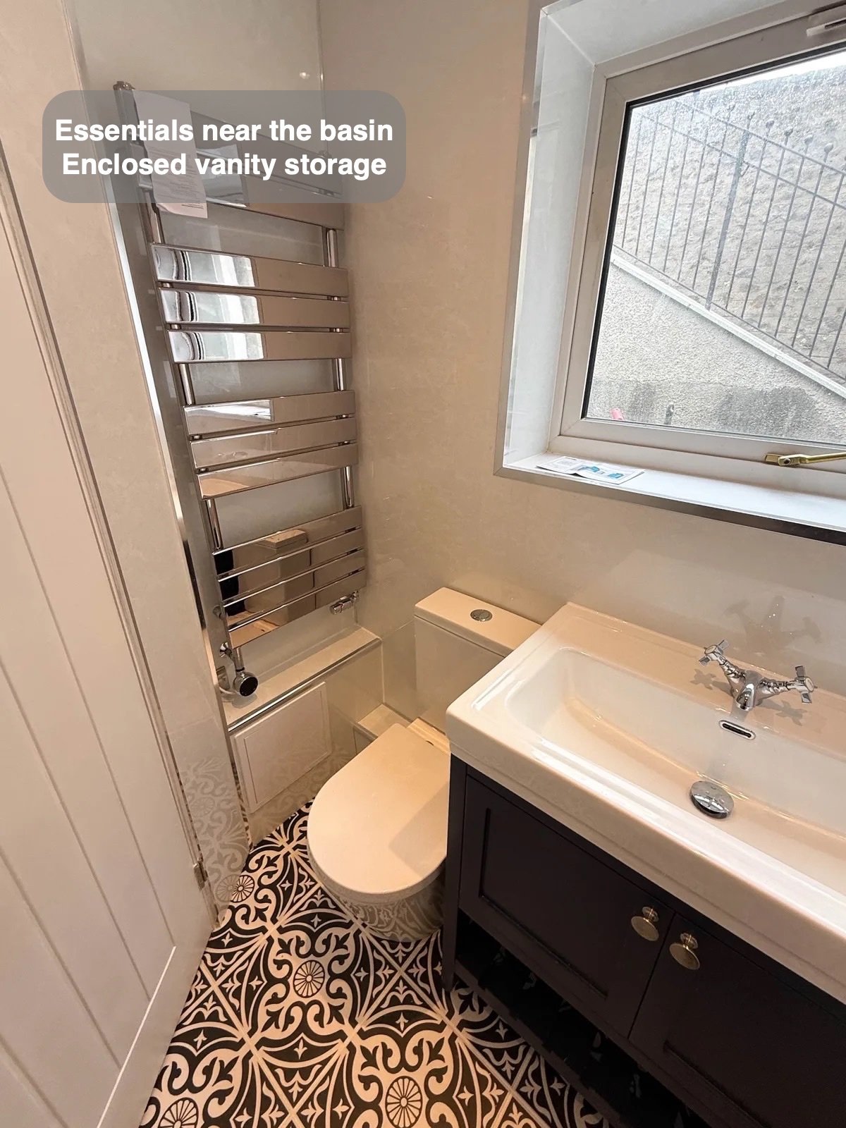 Vanity and toilet beside window