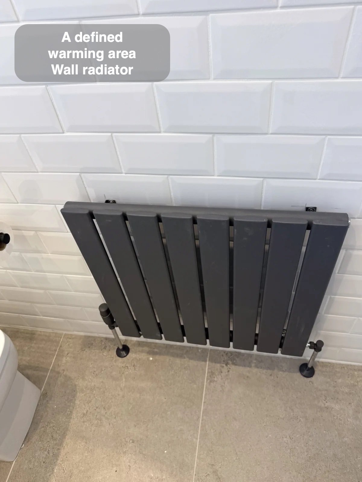 Anthracite radiator on white metro tiles