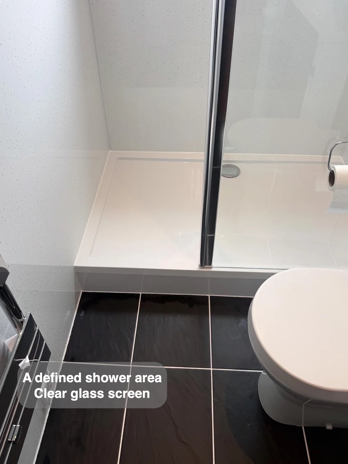 Shower tray beside toilet