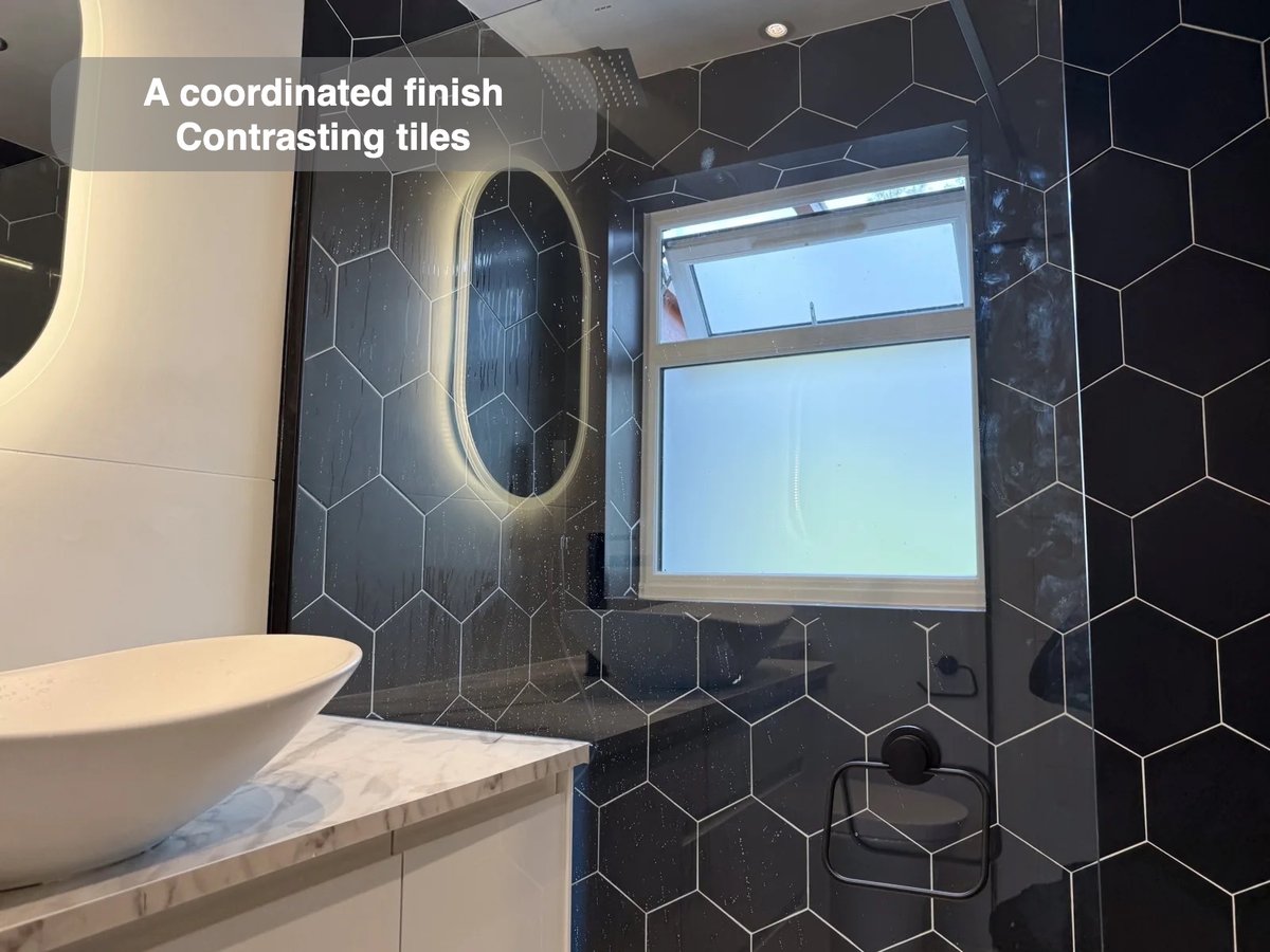 Window and basin beside contrasting tiled shower