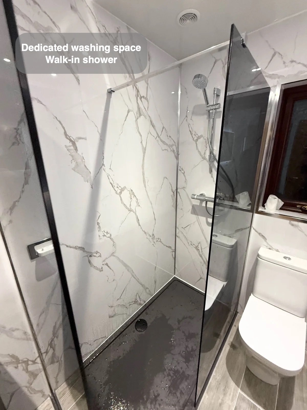 Walk-in shower with dark tray