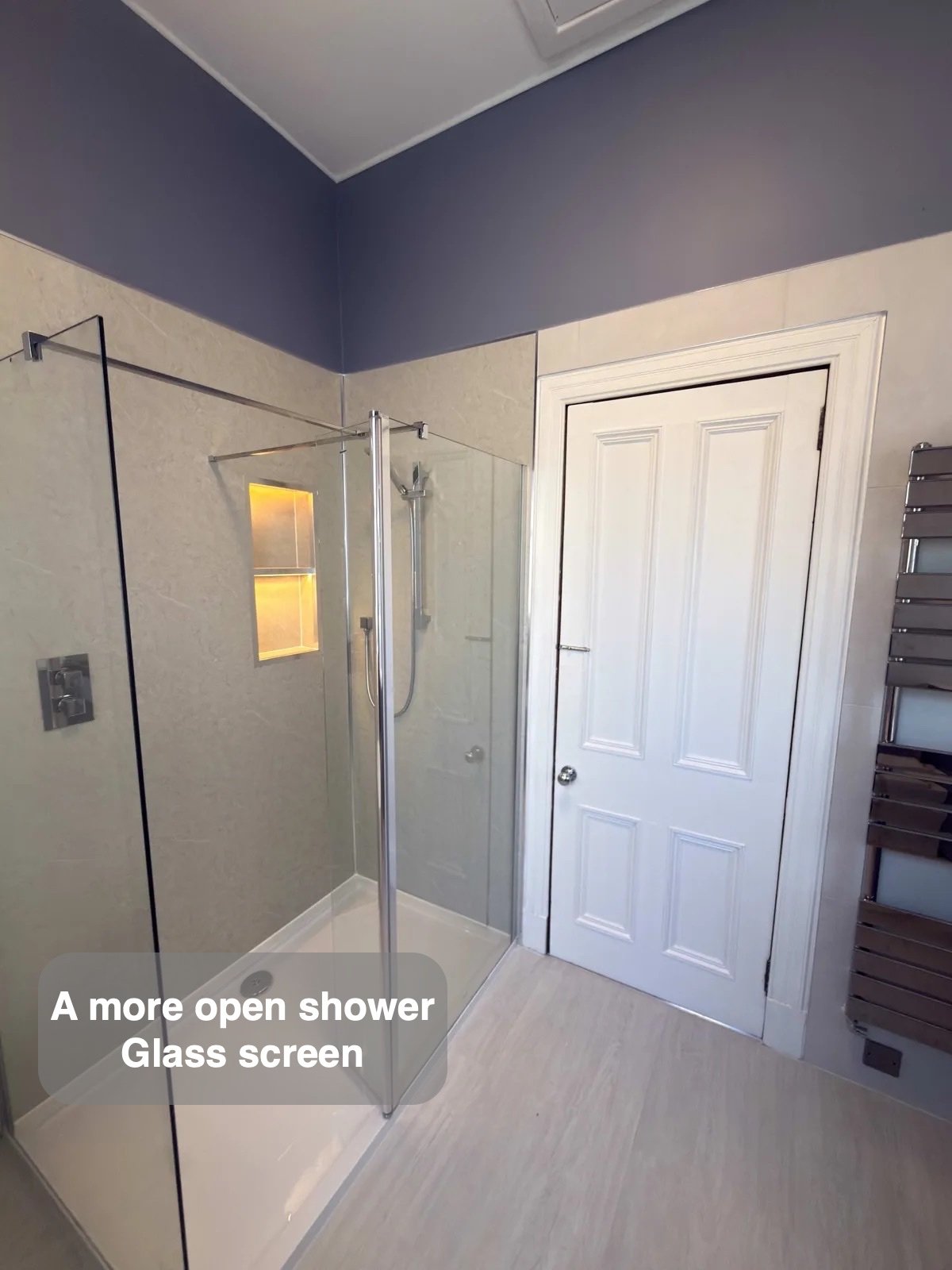 Walk-in shower with glass screen and illuminated shelf