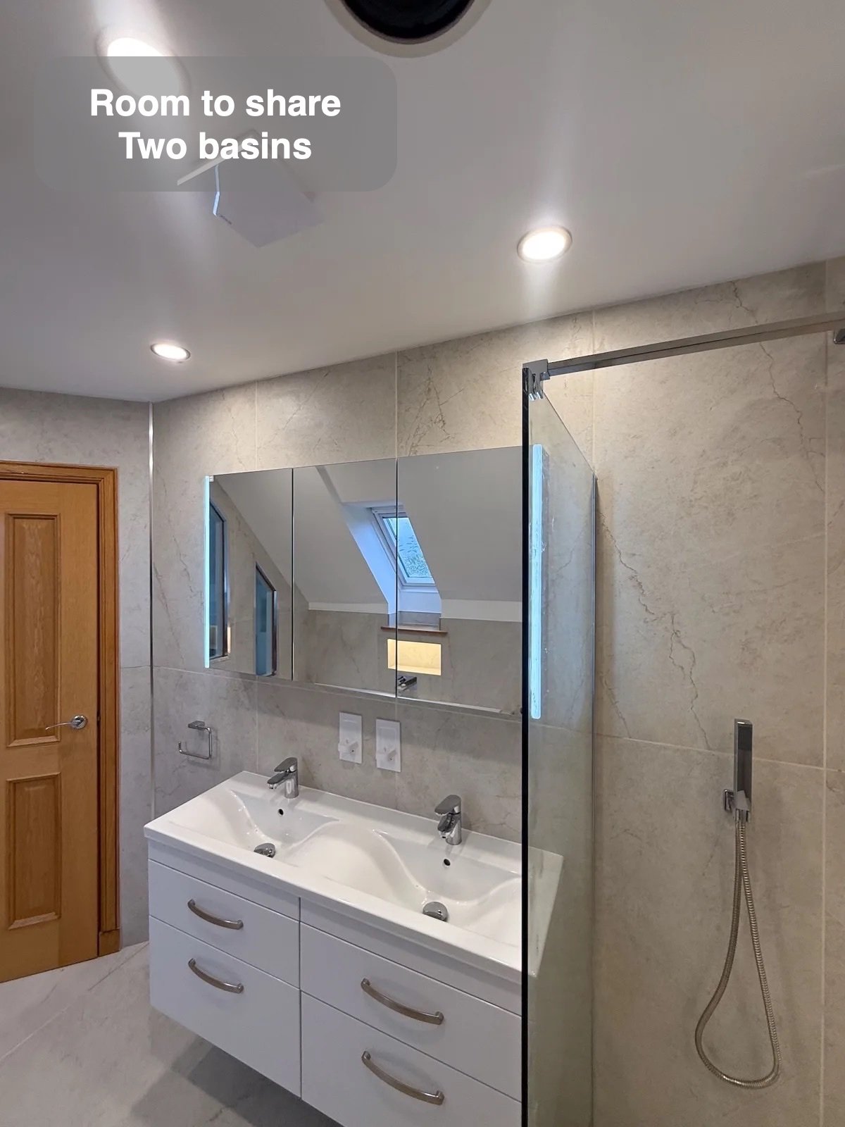 Double vanity beside the glass shower screen