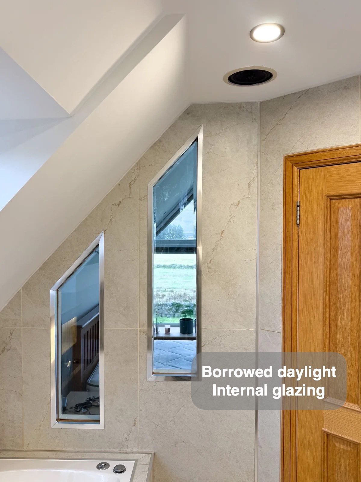 Angled internal glazing beneath the sloping ceiling