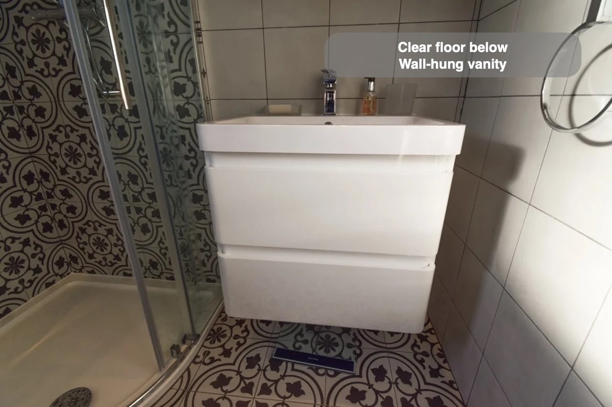 A clearer floor beneath the basin in the completed Westhill bathroom