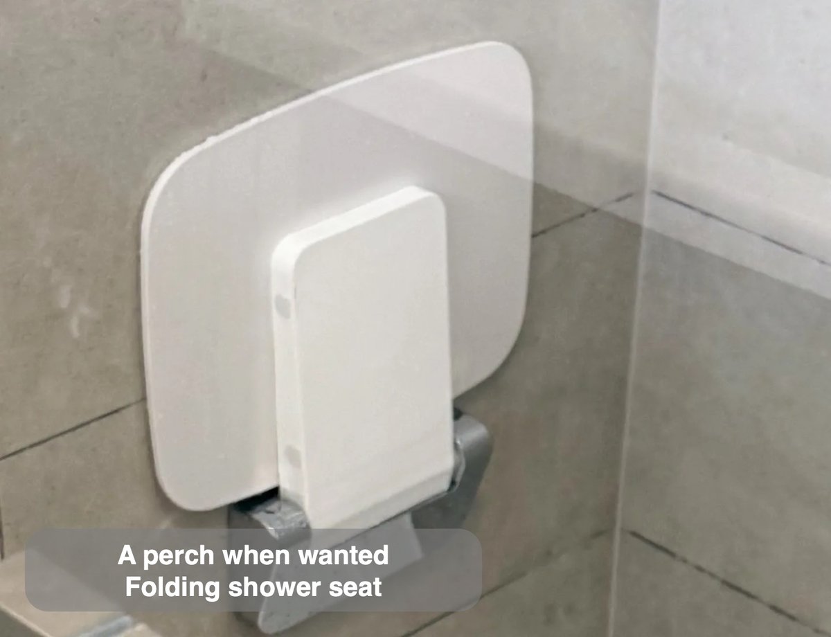 A defined shower with a folding seat in the completed Stoneywood, Aberdeen bathroom