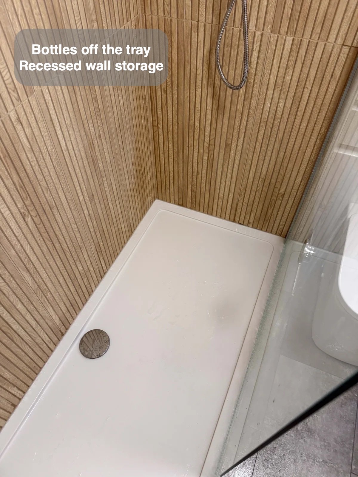 Long shower tray beside glass screen