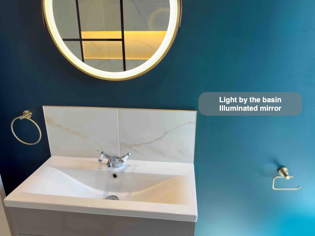 Basin splashback and illuminated round mirror