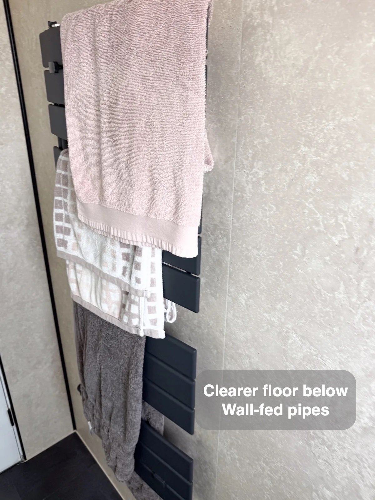 Towel radiator on panelled wall