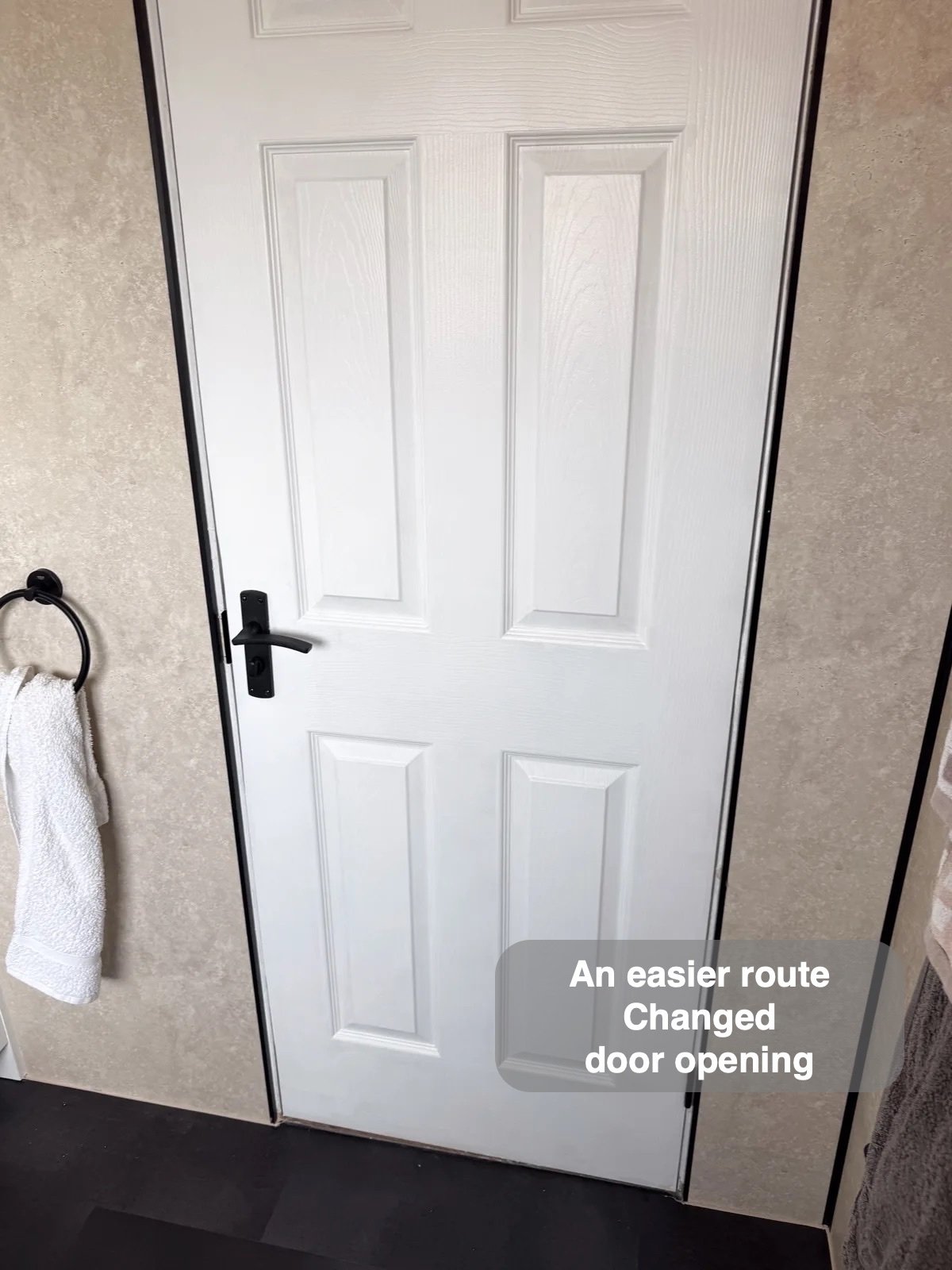 Refitted door within panelled bathroom