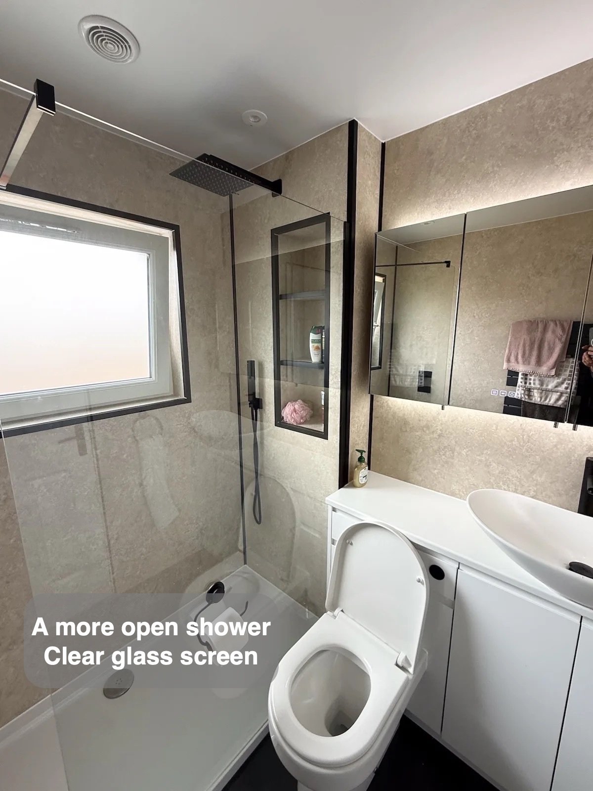 Large shower beside window and basin furniture