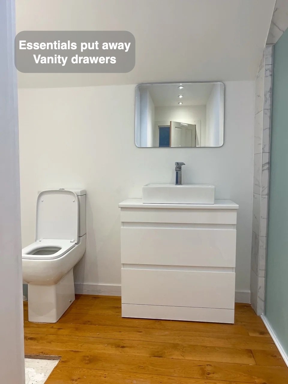 Storage close to the basin in the completed Ellon bathroom