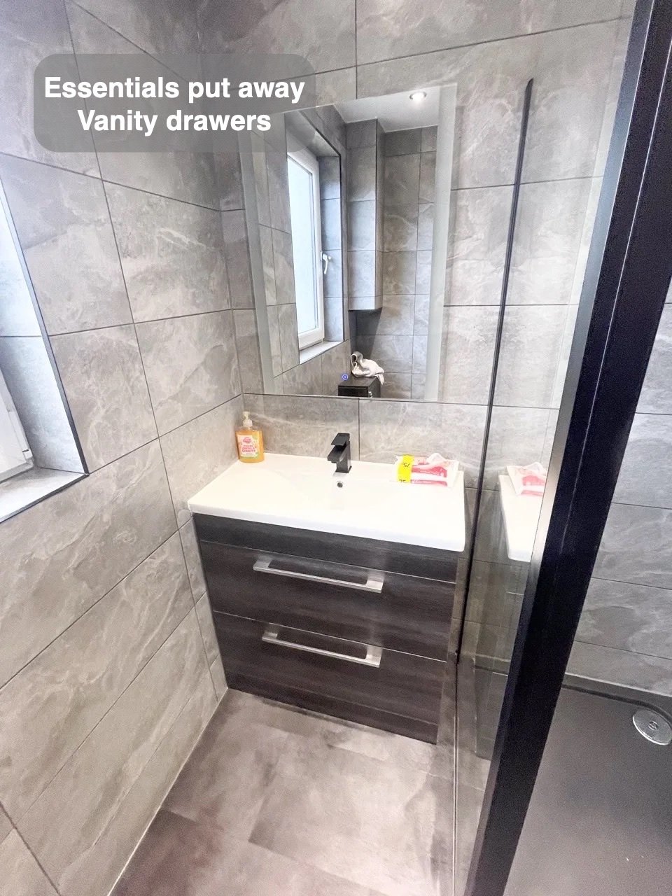 Storage close to the basin in the completed Mastrick, Aberdeen bathroom
