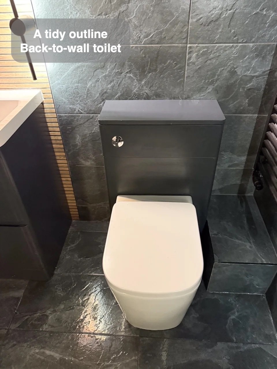Back-to-wall toilet against fully tiled wall