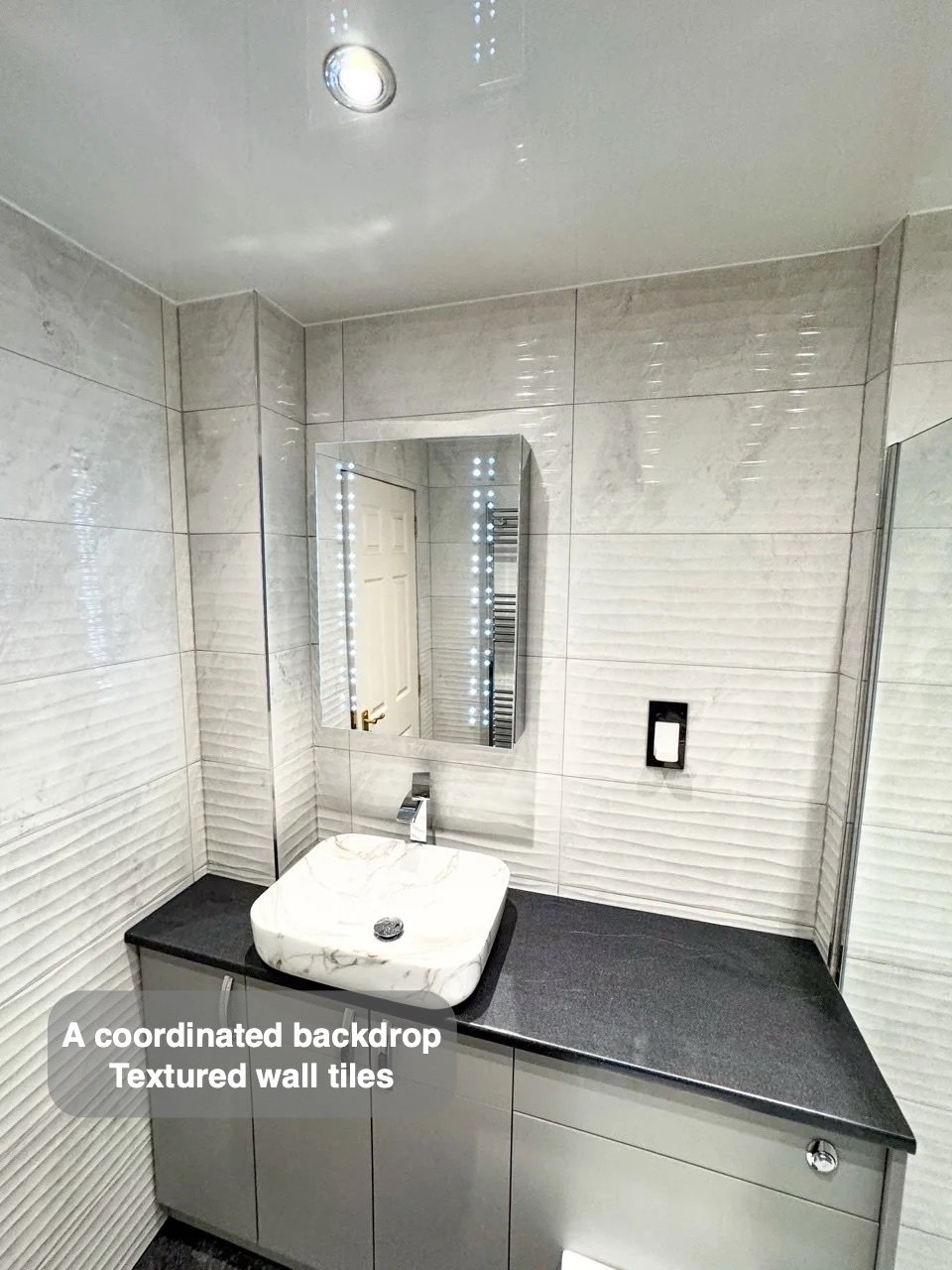 Wave-effect tiles behind basin