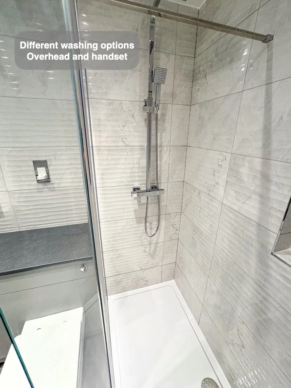 Walk-in shower beside fitted furniture