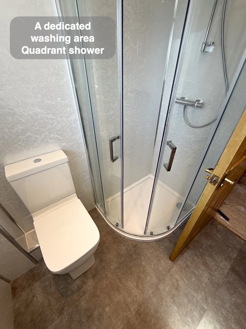 Quadrant shower beside relocated toilet