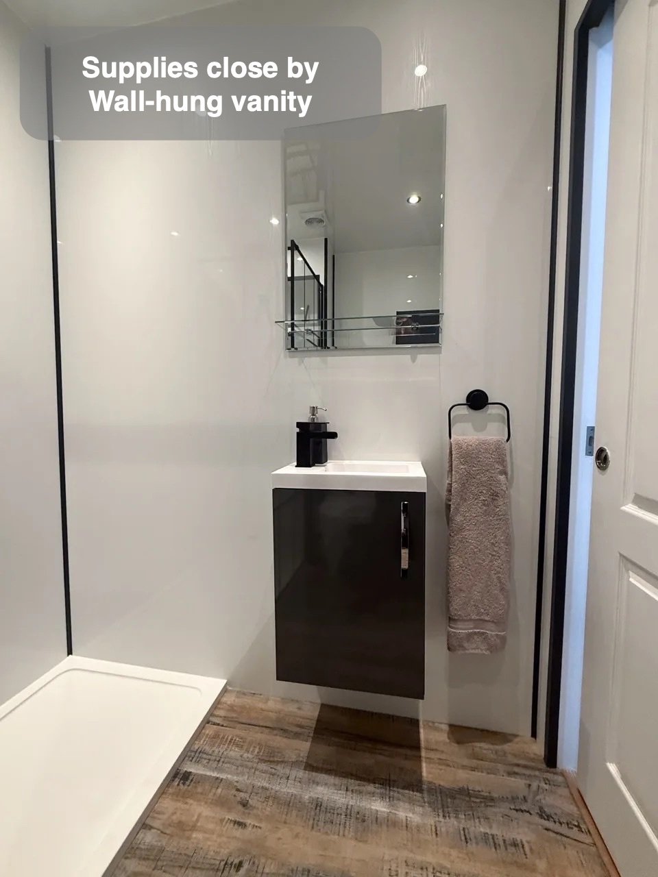 Storage without more floor furniture in the completed Stonehaven bathroom