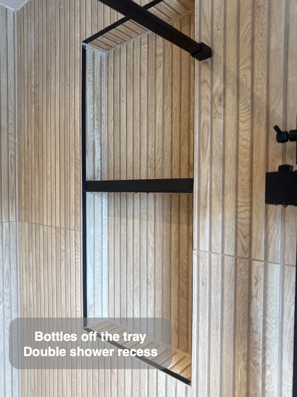 Bottles stored inside the shower wall in the completed Ellon bathroom