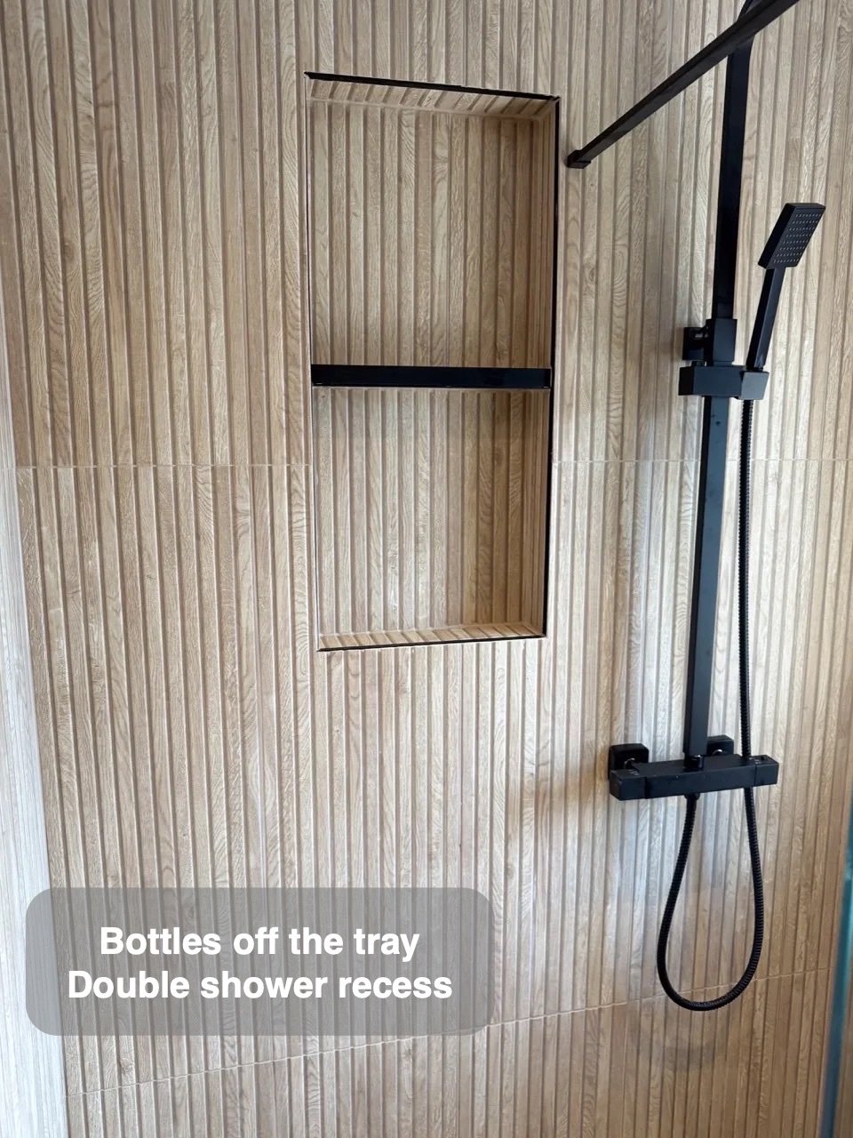 Bottles stored inside the shower wall in the completed Ellon bathroom