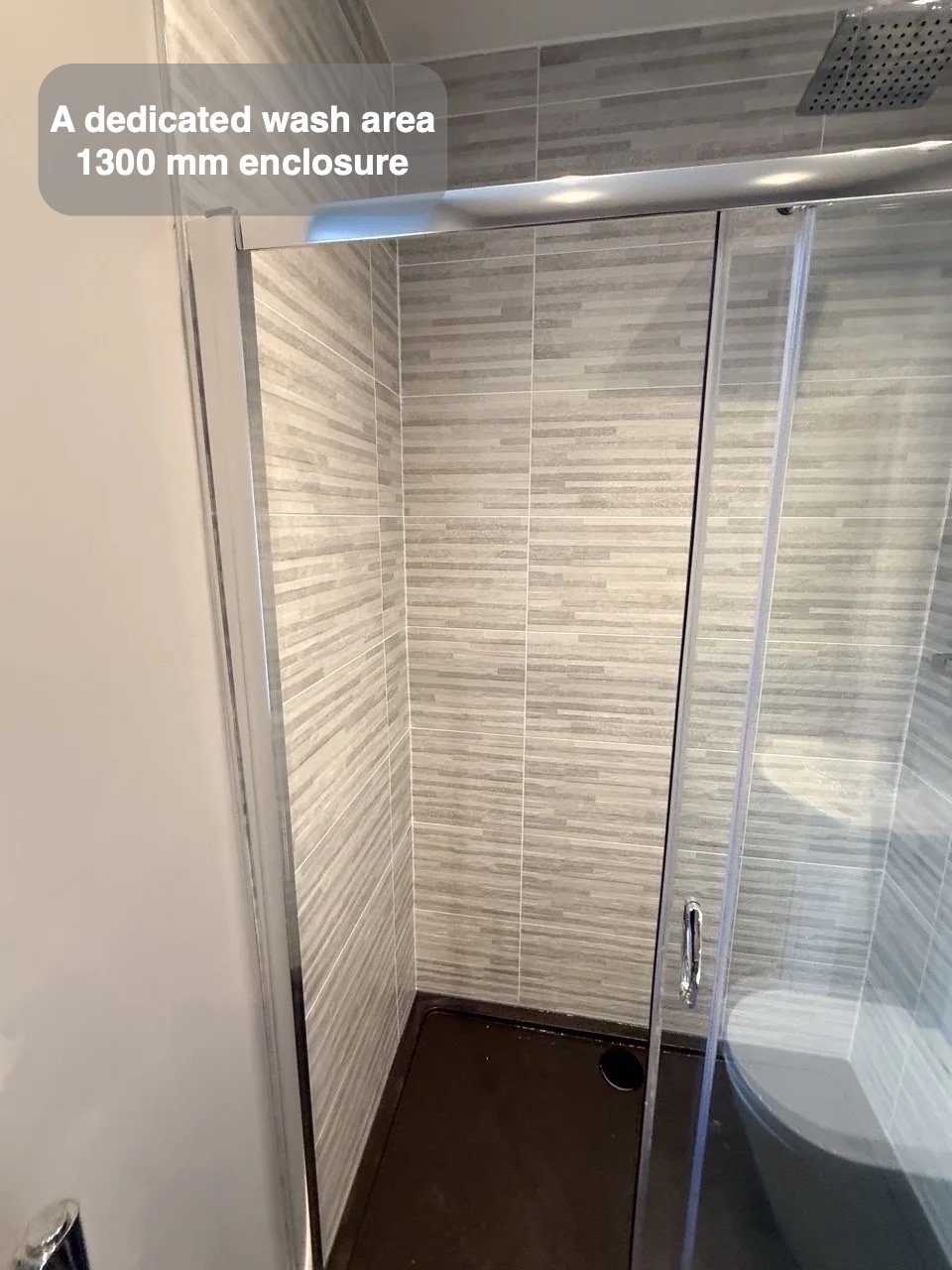 Shower enclosure at end of narrow room