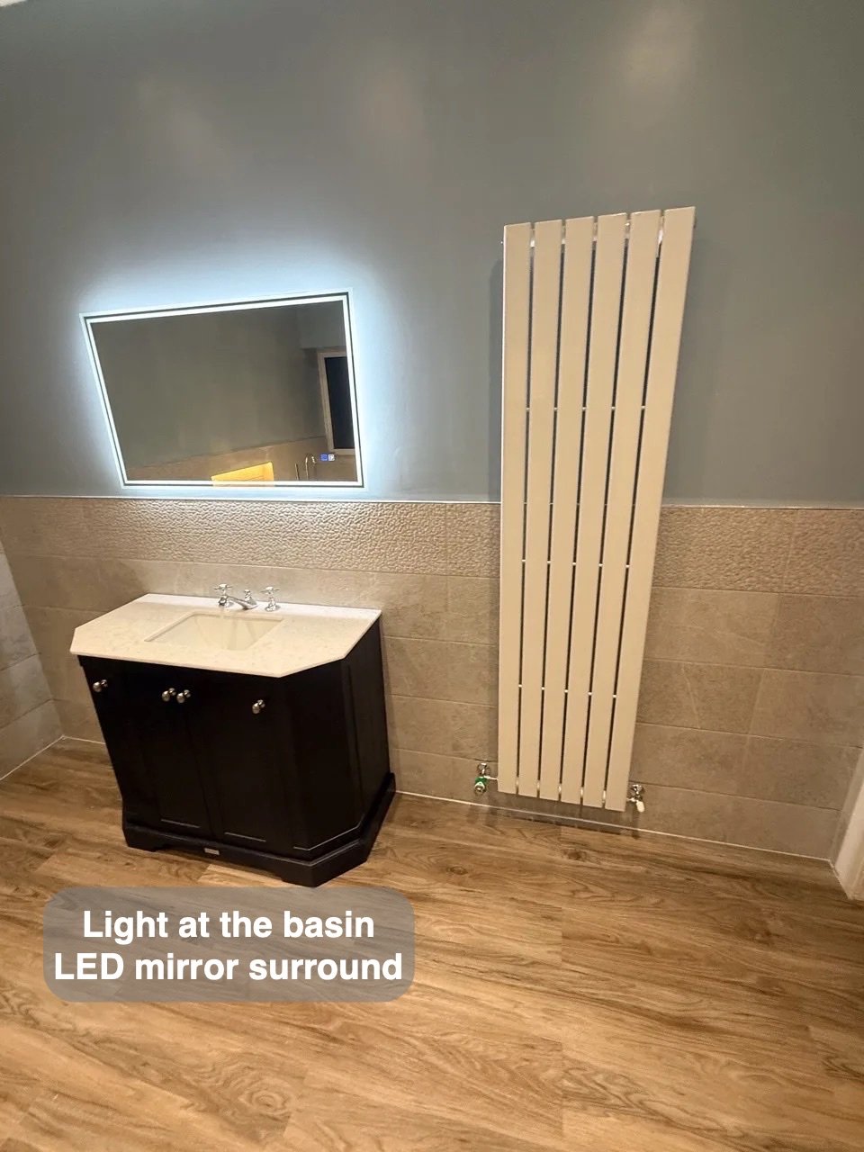 Vanity and tall white radiator