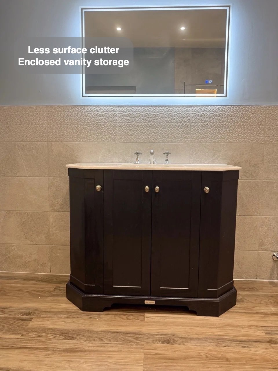 Dark vanity below LED mirror