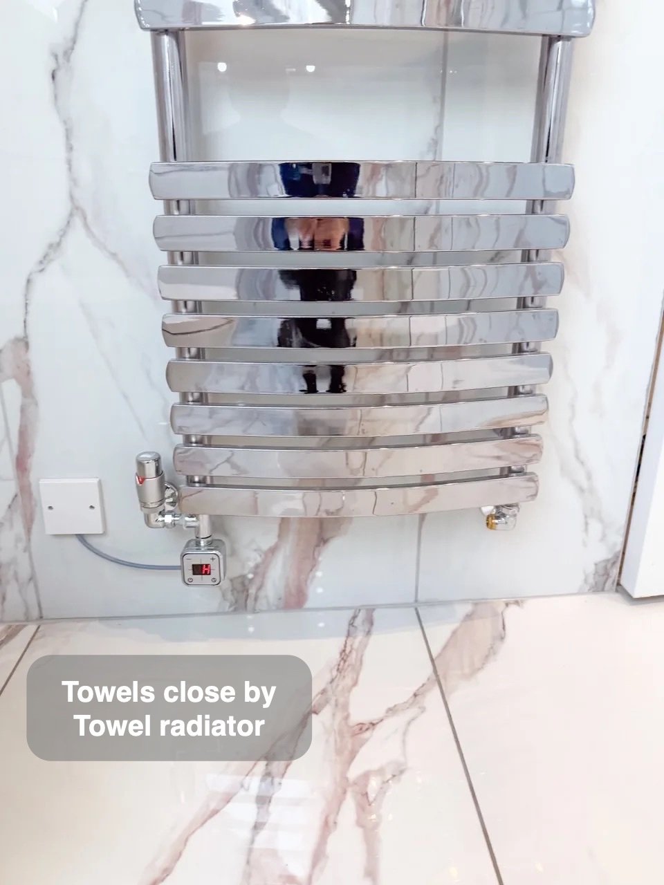 Chrome towel radiator with wall-fed pipes