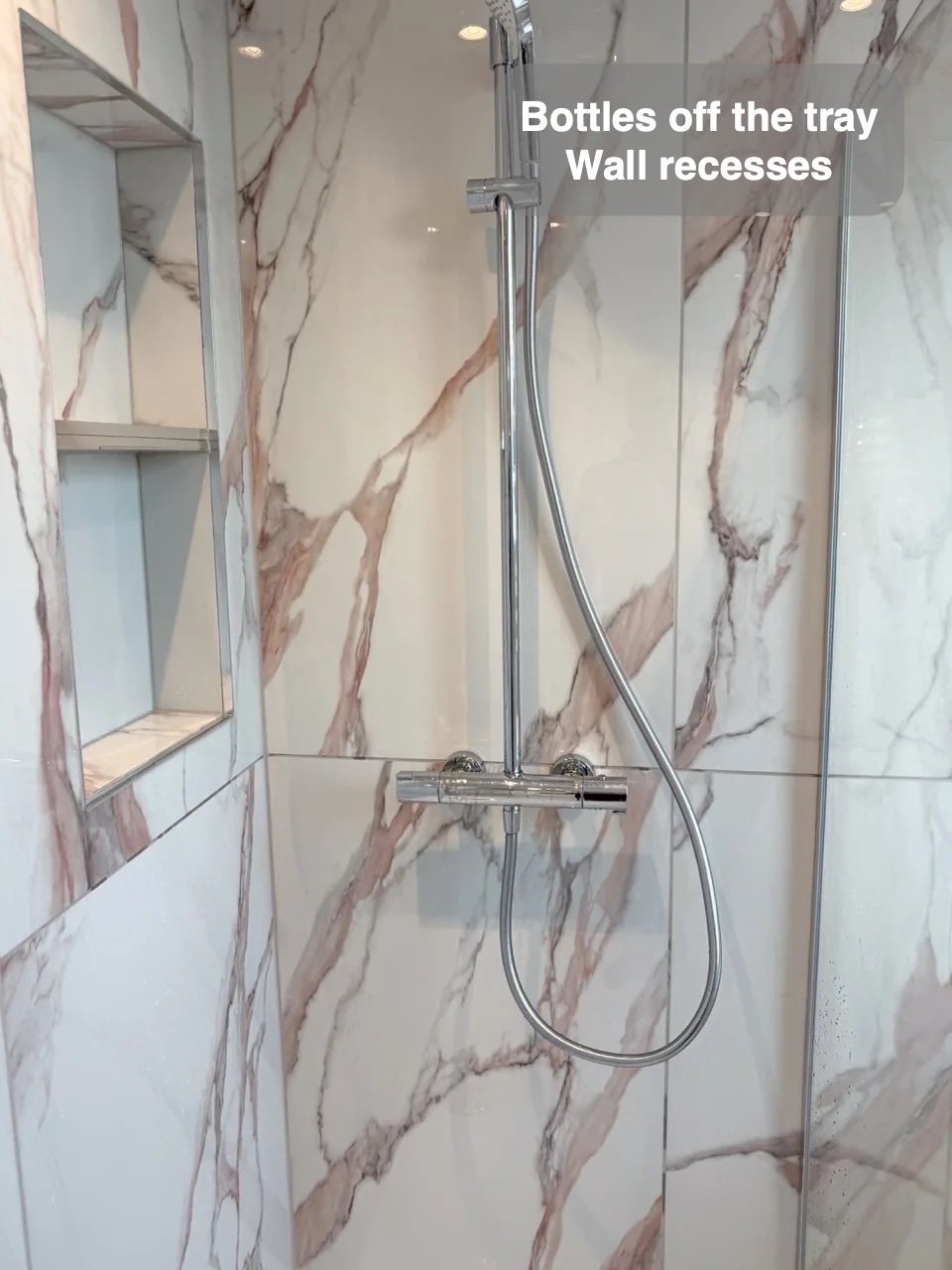 Shower fittings alongside recessed wall storage