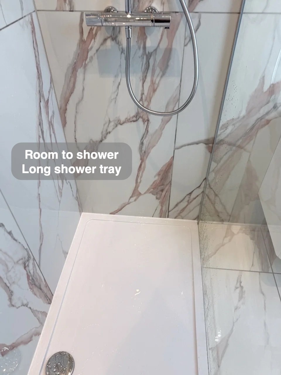 Long shower tray beneath the handset and overhead shower