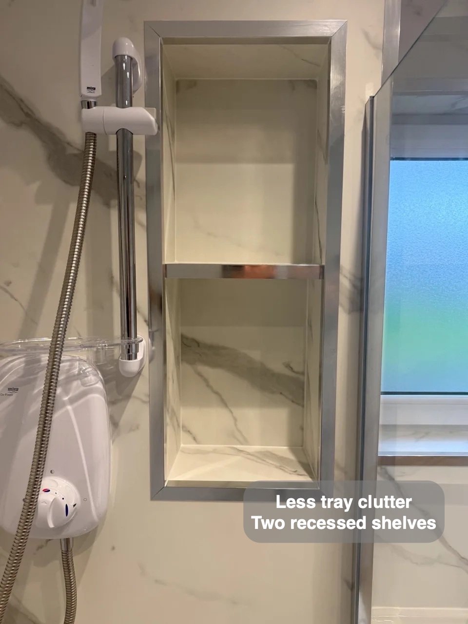 Two shower niches beside handset